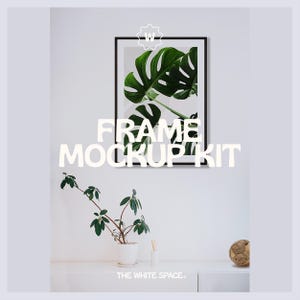 May include: A black frame mockup kit with a green leaf print inside the frame. The frame is hanging on a white wall. There is a small plant in a white pot and a wooden ball on a white shelf below the frame.