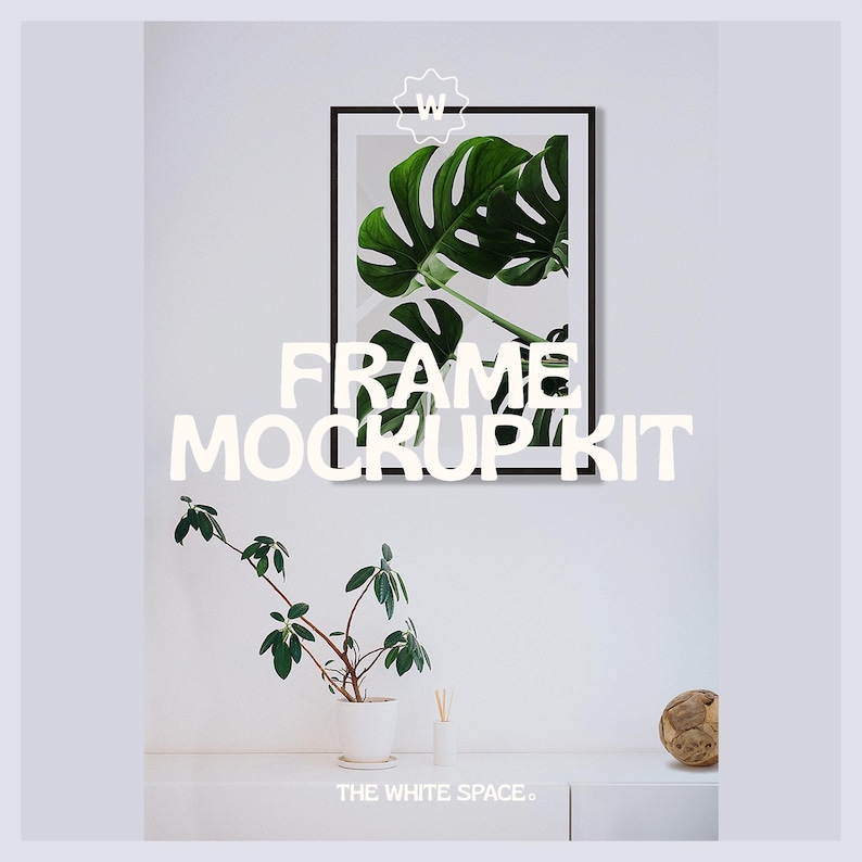 May include: A black frame mockup kit with a green leaf print inside the frame. The frame is hanging on a white wall. There is a small plant in a white pot and a wooden ball on a white shelf below the frame.