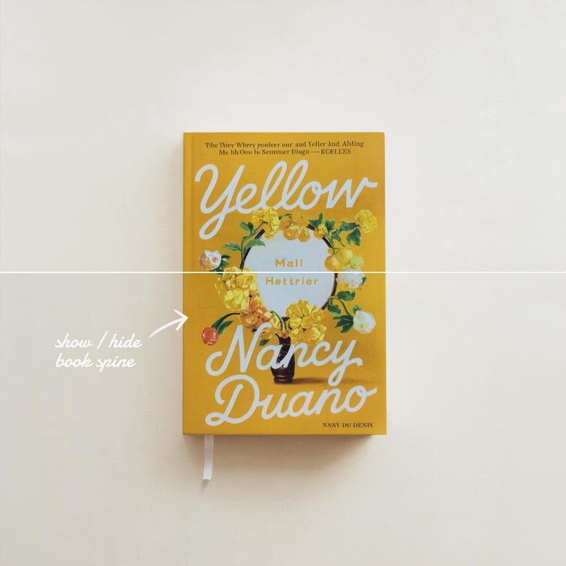 May include: A yellow paperback book titled "Yellow" by Nancy Dueno. The cover features a floral arrangement with a yellow background.