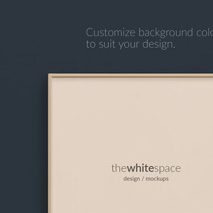 May include: A light beige mockup frame with a gold border, against a dark blue background. The frame has the text "thewhitespace design / mockups" at the bottom.
