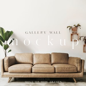 May include: A mockup of a gallery wall with a brown leather sofa in front of it. The wall has three wooden shelves with plants and decorative items on them. The text "GALLERY WALL MOCKUP" is written in white on the wall. The text "LAYERED FILES MOVE OR HIDE FRAMES" is written in black at the bottom of the image.
