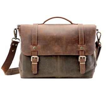 May include: A brown leather and canvas messenger bag with a flap closure and two buckles. The bag has a brown leather shoulder strap and a brass buckle on the strap.