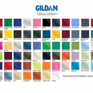May include: A colour chart displaying 48 different colours of Gildan Ultra Cotton T-shirts. The colours are arranged in rows and columns, with each colour labelled with its name. The text "Not all sizes are available in every colour." is at the bottom of the chart.