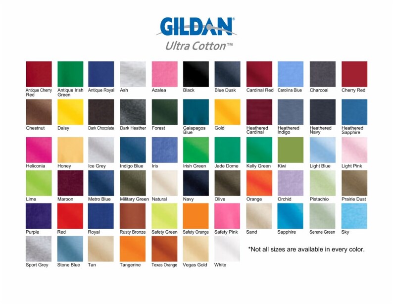 May include: A colour chart displaying 48 different colours of Gildan Ultra Cotton T-shirts. The colours are arranged in rows and columns, with each colour labelled with its name. The text "Not all sizes are available in every colour." is at the bottom of the chart.