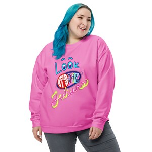 May include: A pink sweatshirt with a graphic design that says "Look It's The Future" in a colorful, retro style.