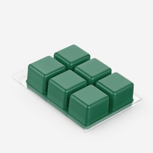 May include: A clear plastic clamshell package containing six dark green wax melt cubes. The cubes are square and evenly spaced, with a glossy finish. The package is on a white background.