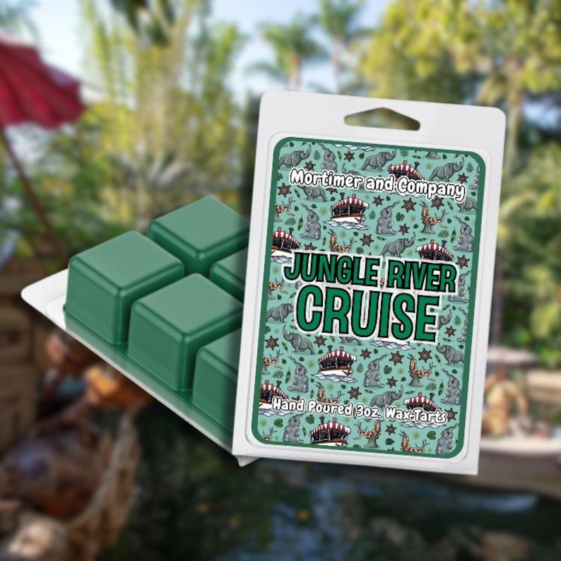 May include: A package of green wax melts with the text "Jungle River Cruise" and a patterned design of elephants, boats, and stars. The wax melts are in a white plastic container. The product is labeled "Mortimer and Company."