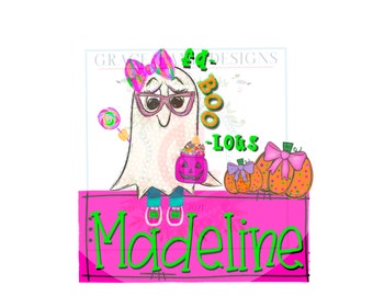 May include: A whimsical Halloween-themed illustration featuring a ghost character with glasses, a bow, and a lollipop. The design includes pumpkins, the text "Boo-Lots", and the name "Madeline" in green on a pink background.