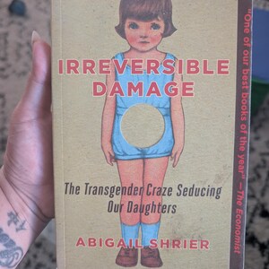 Paperback copy of Irreversible Damage by Abigail Shrier, nonfiction book discussing parenting, youth gender identity, and contemporary socia