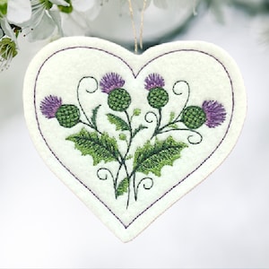 Scottish Thistle in a Heart Shaped Ornament Embroidered on White Felt with 2 Purples and 2 Greens. Beautiful colors and dimension.