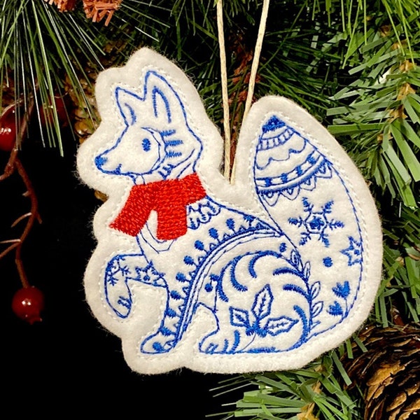 Winter Fox Ornament Embroidered on White Felt with Blue Accents and a Red Scarf. Polar Fox with Folk Art Designs.