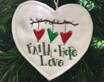 Primitive Hearts Faith Hope Love Ornament. Trio of Prim Hearts Tied to a Branch Embroidered on Felt with Faith Hope and Love below.