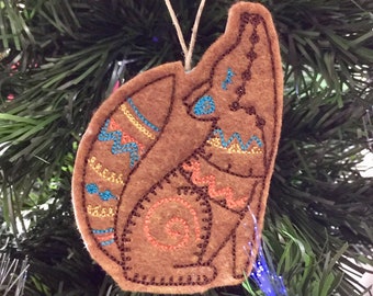 Southwest Coyote Ornament. Felt Coyote Ornament Embroidered on Reddish Brown Felt with Colorful Stitching.