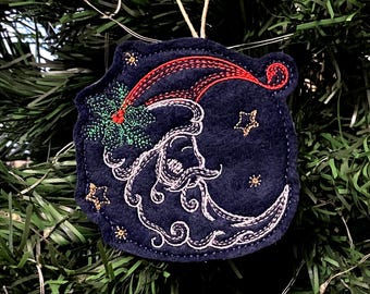 Santa Face in Crescent Moon Shape Embroidered on Navy Blue Felt with Multiple Thread Colors. Red Santa Hat with Green Holly, Gold Stars.