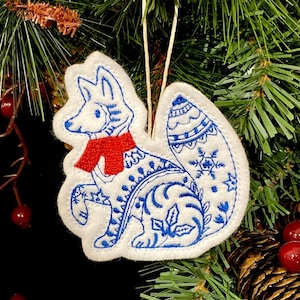 Winter Fox Ornament Embroidered on White Felt with Blue Accents and a Red Scarf. Polar Fox with Folk Art Designs.