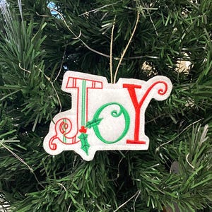 Striped JOY Christmas Tree Ornament Embroidered on White Felt with Red and Green Threads. Holly Leaves on Artistic JOY Holiday Decor.