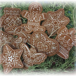 Set of 9 Dark Gingerbread Christmas Cookie Ornaments. Felt Gingerbread Cookies with White Embroidered Icing Designs and Twine Hanging Loops.