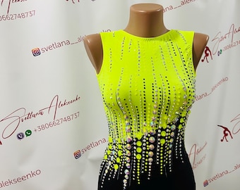 May include: A sleeveless, neon yellow and black leotard with a scoop neck. The bodice is decorated with a pattern of small, sparkling rhinestones. The leotard is displayed on a mannequin.