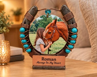 May include: A horseshoe-shaped photo frame featuring a central circular image of a person with a brown horse. The frame is decorated with copper wire coils and turquoise beads. A rectangular base plate displays the text Roman Always In My Heart.