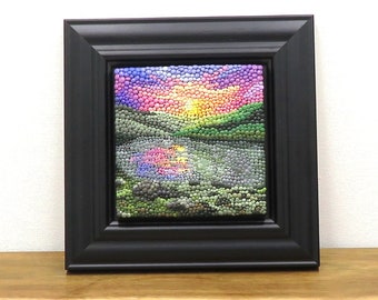 Sunrise wall art made with polymer clay. This small, framed dot art depicts a colourful sunrise over a lake and has a Christian theme