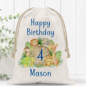 May include: A white canvas drawstring bag with a blue and brown design. The bag features a happy birthday message, the number 4, and the name Mason. The design includes a lion, elephant, monkey, giraffe, and turtle.