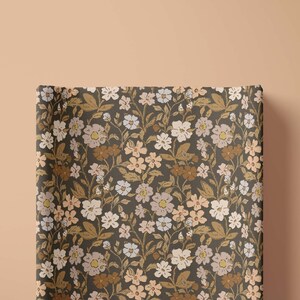 top view of the most requested changing pad cover with beautiful hand drawn bohemian flowers and floral design in a dark charcoal background that can also be used as a lounger cover perfect for baby shower gift or new mom gifts