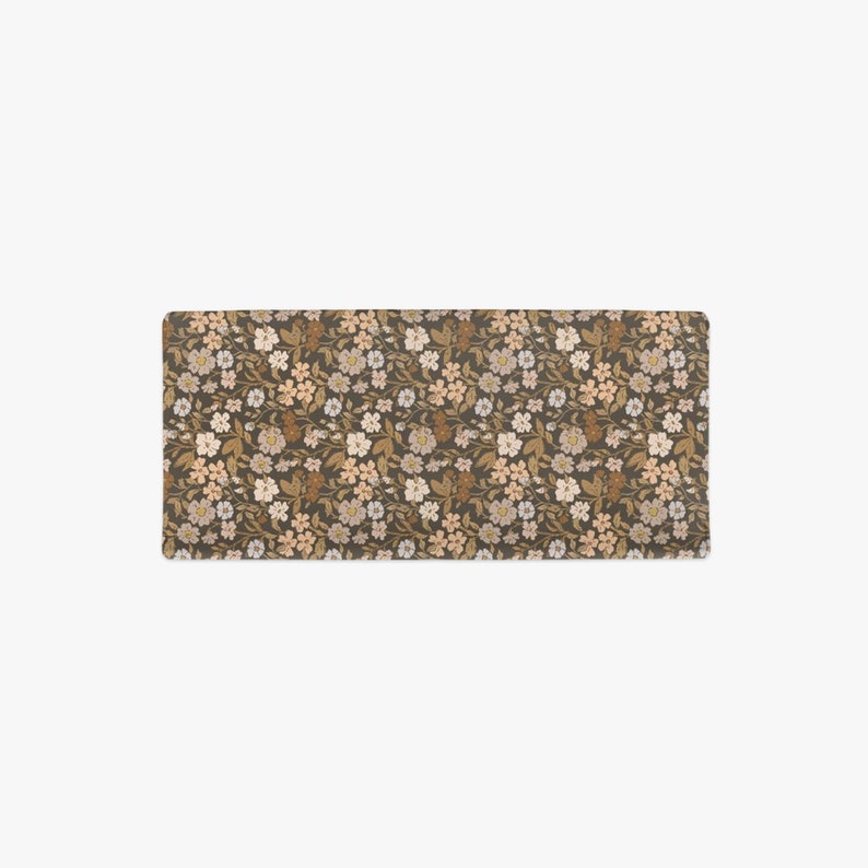 Top view of a floral changing pad cover from Mini Wander