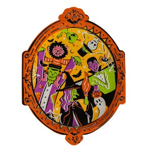 Puede incluir: Un plato de papel ovalado con un borde decorativo naranja que presenta una ilustración de Halloween. El diseño incluye una bruja, un vampiro, un fantasma, un esqueleto, un hombre lobo y un alienígena verde rodeados de murciélagos y estrellas.
