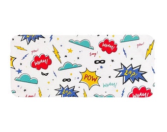 May include: A white background with a repeating pattern of colorful comic book speech bubbles with words like "WHAM!" and "POW!" and other superhero-themed graphics like lightning bolts, stars, and masks.