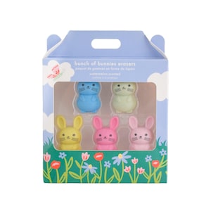 May include: A box of six bunny-shaped erasers in pastel colors: blue, green, yellow, and pink. The box is light blue with a floral and grass design. Text on the box reads "bunch of bunnies erasers" and "watermelon scented".