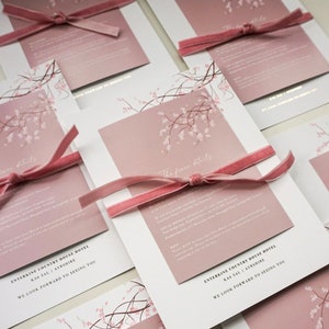 Gold foiled blush pink wedding invitations with cherry blossom detail. Includes main invite, details card, ribbon, envelopes and liners