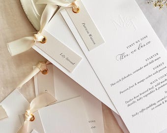 Modern wedding menu and name cards with embossing and cream satin ribbon tie. Printed on hammered card