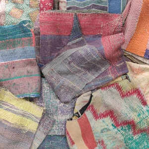 May include: A collection of colourful patchwork fabric squares, each with a unique pattern and texture. The fabrics are made of cotton and are hand-stitched together. The squares are arranged in a random order, creating a visually appealing and interesting design.