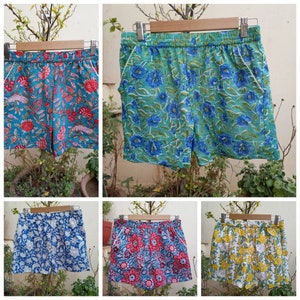 May include: Four pairs of floral print shorts. The shorts are made of a lightweight fabric and have an elastic waistband. The prints feature a variety of colors, including blue, green, red, and yellow.