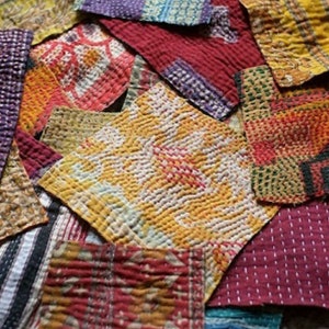 May include: A collection of colorful fabric squares with intricate stitching and patterns. The squares are made of various materials, including cotton and silk. The fabric squares are arranged in a random pattern, creating a visually appealing and textured surface.