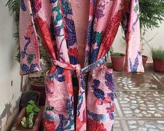 May include: A pink floral patterned robe with a tie belt and pockets. The robe is made of a soft, quilted fabric.