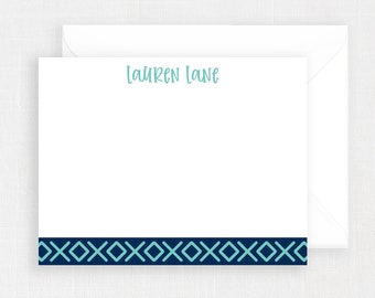 May include: A white stationery card with a blue and teal border. The card has the name "Lauren Lane" printed in teal at the top.