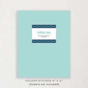 May include: A light blue folder sticker with a dark blue geometric border and the text "Lauren Lane" and "Edmond North High School, Edmond, OK". The sticker is 4 inches by 3 inches.