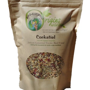 May include: A brown paper bag with a clear window showing a mix of bird seed. The bag has a logo with a cartoon bird and the text "Bird-Elicious Origins Wild Diet". The text "Cockatiel Artisan Gourmet Exotic Bird Food" is printed on the bag. The text "Now with digestive enzymes!" is printed on the bag. The text "Setting the standards for exotic avian nutrition!" is printed on the bag. The text "Vacuum-Packed with an unopened package shelf life of up to 1 year!" is printed below the bag.