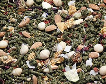 May include: A close-up of a mix of dried herbs, fruits, and nuts. The mix is a light green color with brown, red, and white accents. The ingredients are small and appear to be a blend for a pet food or snack.