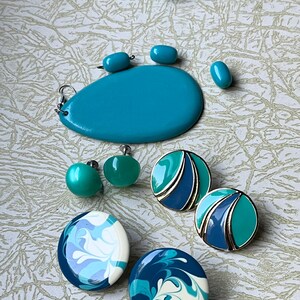 May include: A set of turquoise and blue earrings. The earrings are made of plastic and have a variety of designs, including swirls, geometric shapes, and a solid turquoise color. The earrings are a great addition to any jewelry collection.
