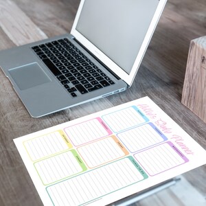 May include: A daily planner sheet with the text "Holly's Daily Planner" in pink script. The planner has boxes for each day of the week, with a "Things to Do" section. A laptop and pen holder are also visible.