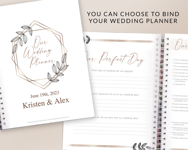 May include: A wedding planner with a gold geometric frame and floral design. The cover says "Our Wedding Planner" and includes the date "June 19th, 2023" and the names "Kristen & Alex". The inside pages have a section titled "Our Perfect Day" with questions about the wedding.