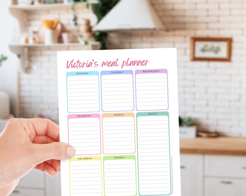 May include: A colorful meal planner titled "Victoria's meal planner" with sections for each day of the week and notes. The planner has a white background with pastel-colored borders around each day's section. The text is in a handwritten style.