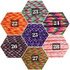 May include: A hexagonal display of eight different patterned paracord ropes, numbered 22 through 28. Each rope is a different color combination, including pink, purple, green, yellow, and brown.