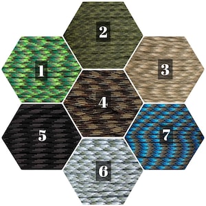 May include: Seven different colors of paracord, each in a hexagonal shape. The colors are green, brown, tan, black, white, blue, and a green and brown camouflage pattern.