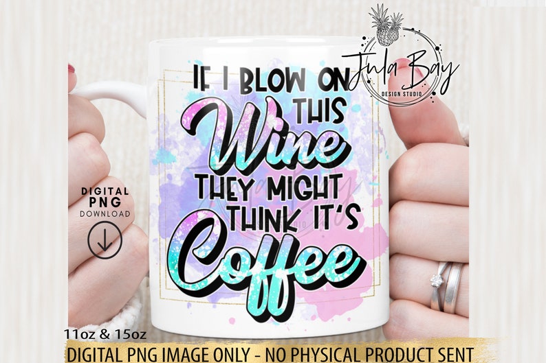 May include: White ceramic mug with the text "IF I BLOW ON THIS WINE THEY MIGHT THINK IT'S COFFEE" in a colorful design. The mug has a gold border and is held by a person. The mug is available in 11oz and 15oz sizes.
