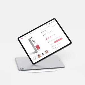 May include: A silver tablet displaying a lipstick product page with a white stylus below. The product page shows a lipstick box with the text "lip hug" and a red accent. The page also shows lipstick color options and model images.
