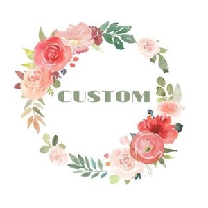 May include: A watercolor wreath with pink, red, and white flowers and green leaves. The word "CUSTOM" is written in the center of the wreath.