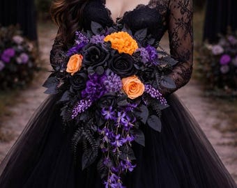 May include: A black wedding dress with a lace bodice and long sleeves. The dress features a full tulle skirt and is paired with a bouquet of black, orange, and purple flowers. The bouquet includes roses and cascading purple blooms.
